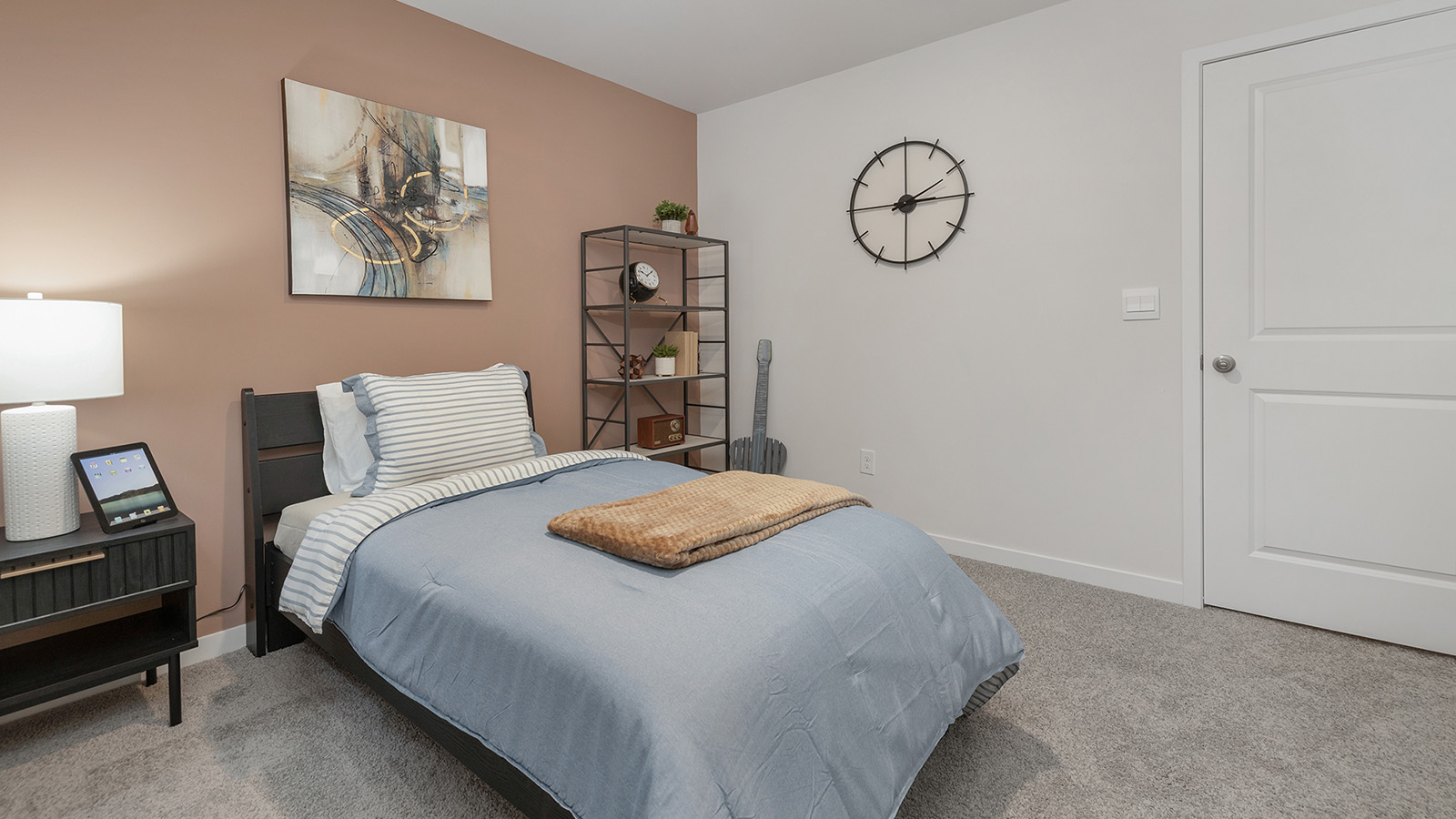 Secondary carpeted bedroom with small window