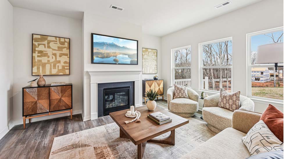 Open concept living area near kitchen and dining area with fireplace and large windowsOpen concept living area near kitchen and dining area with fireplace and large windows