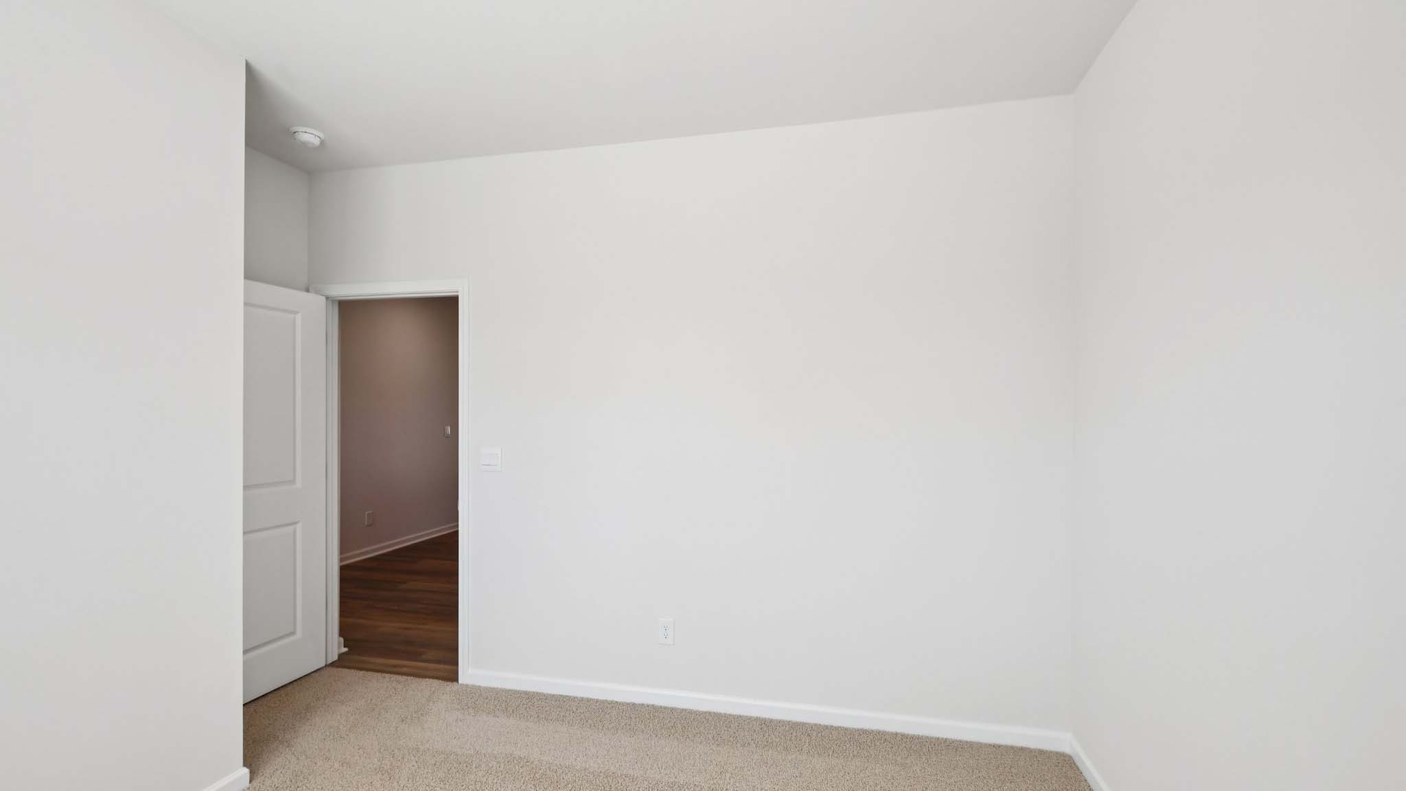Carpeted bedroom with large window