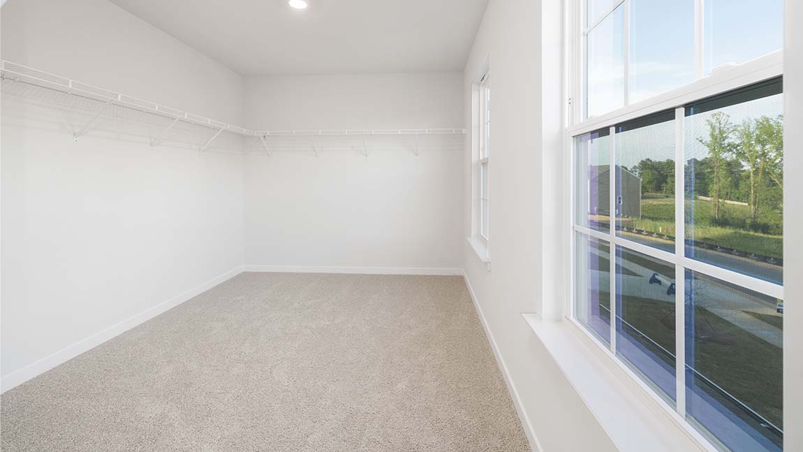 Carpeted bedroom with large window