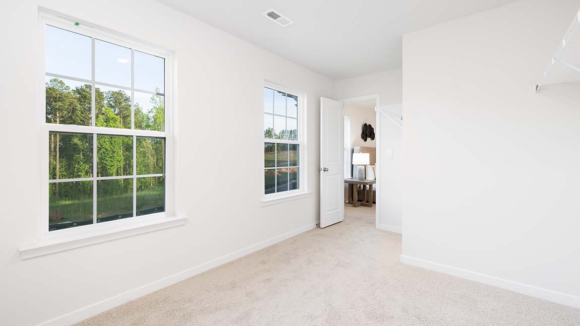 Carpeted bedroom with large window