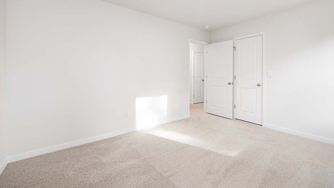 Carpeted bedroom with large window