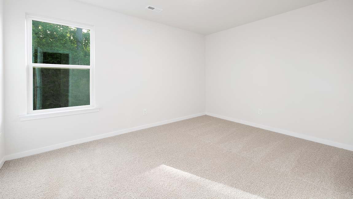 Carpeted bedroom with large window