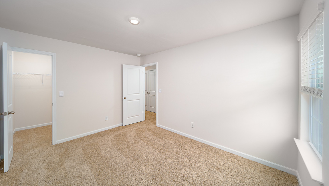 Carpeted bedroom with large window