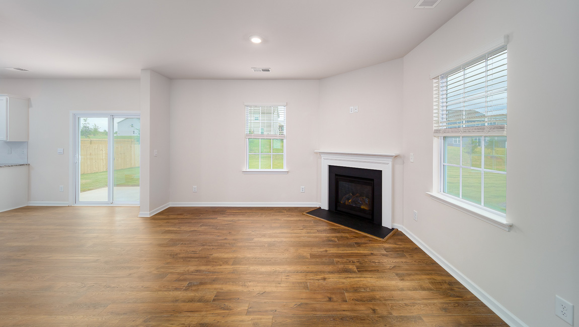 Family room with large windows and fireplace