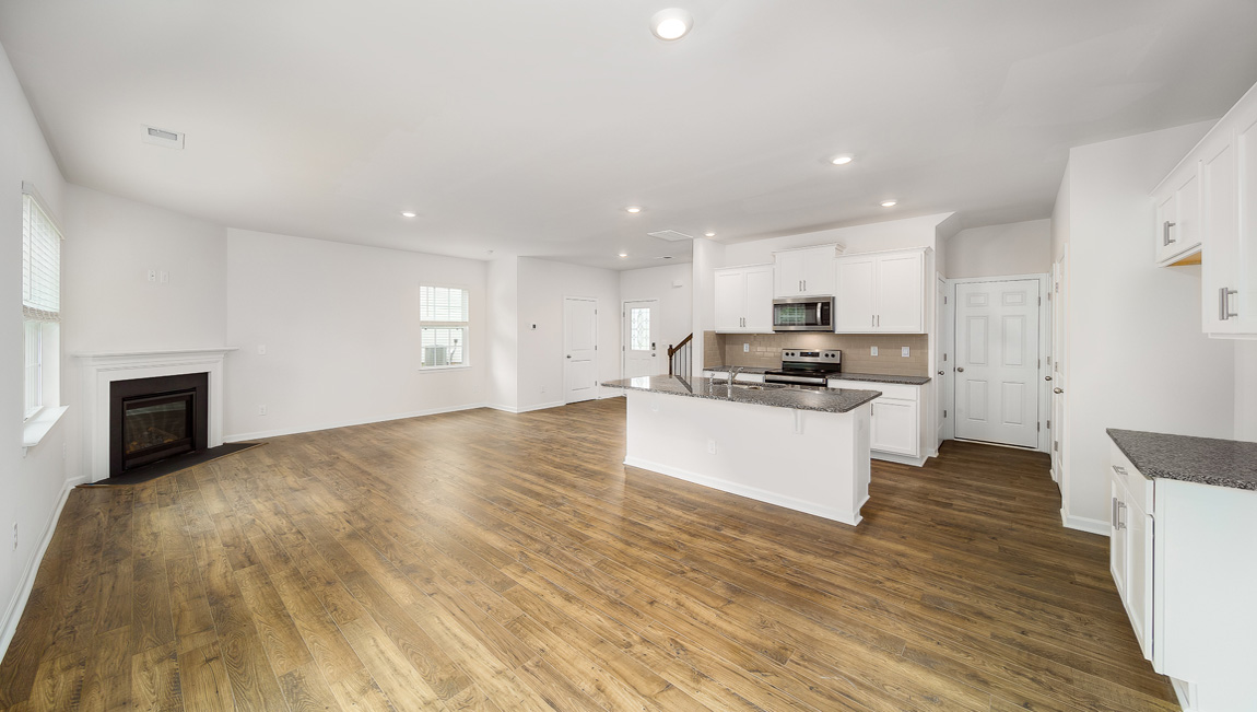 Spacious family room with large windows and fireplace