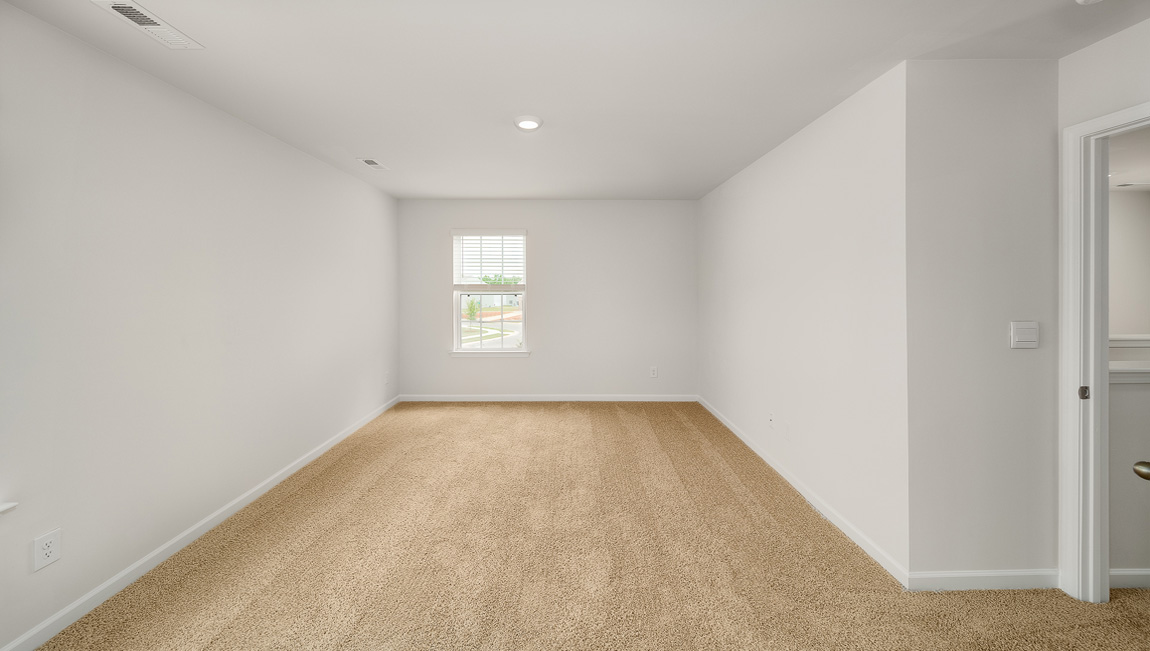 Primary bedroom, carpeted with large windows