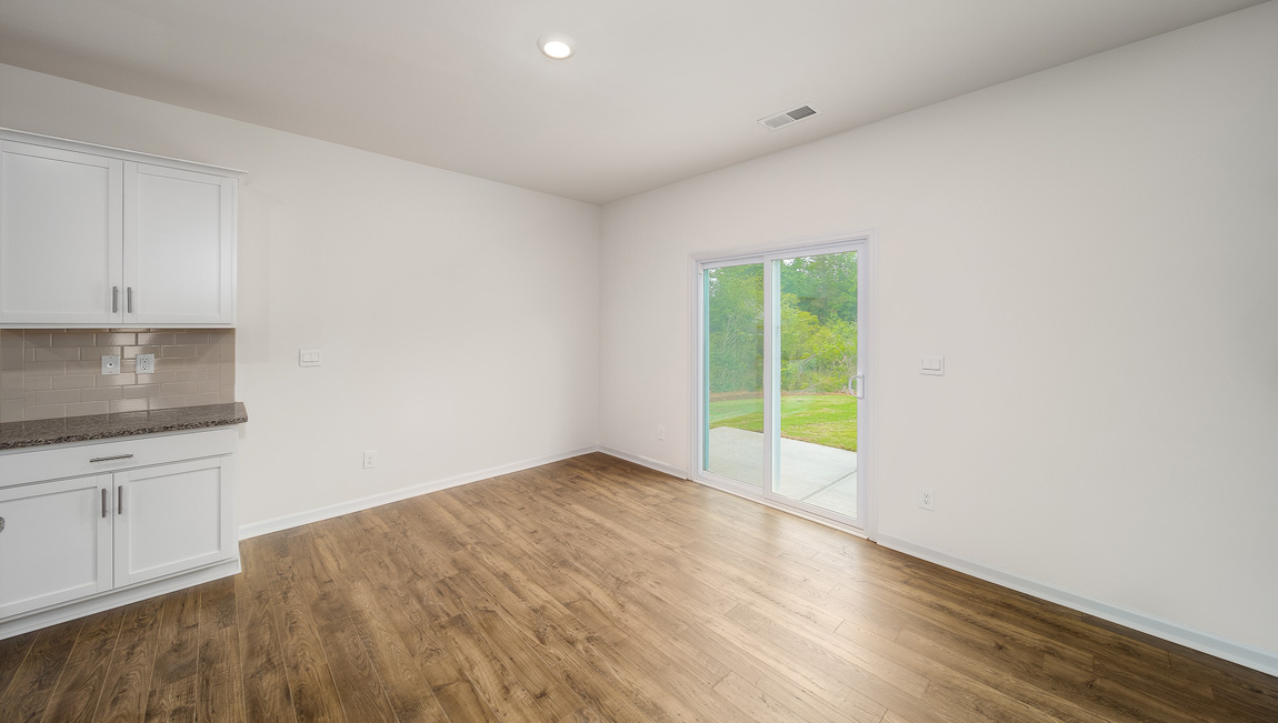 Open dining area near kitchen, with sliding glass doors