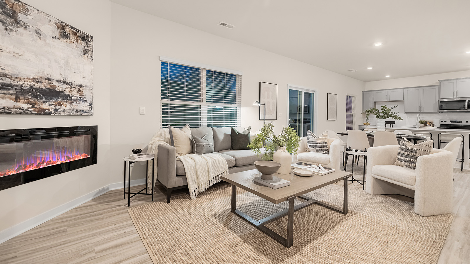 living room with wood floors, electric fireplace and large window