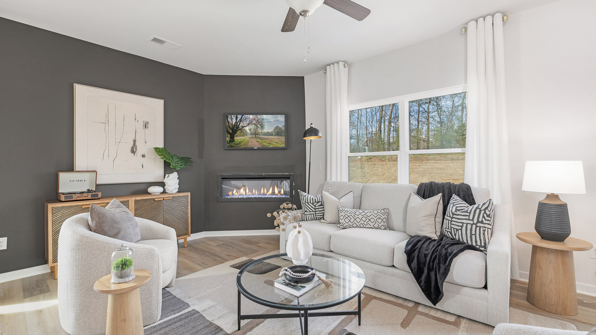 living room with wood floors, electric fireplace and large window