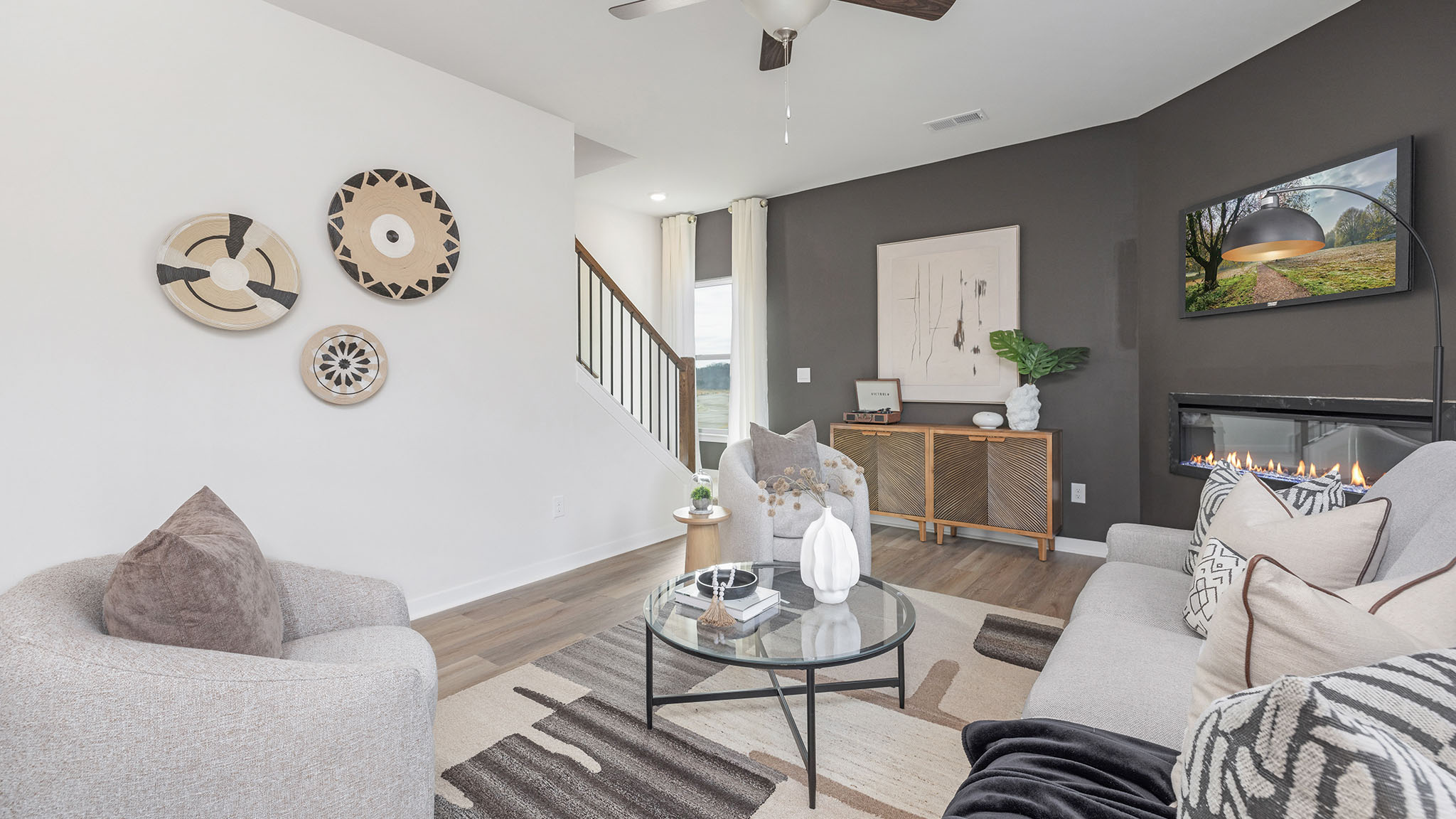 living room with wood floors, electric fireplace and large window
