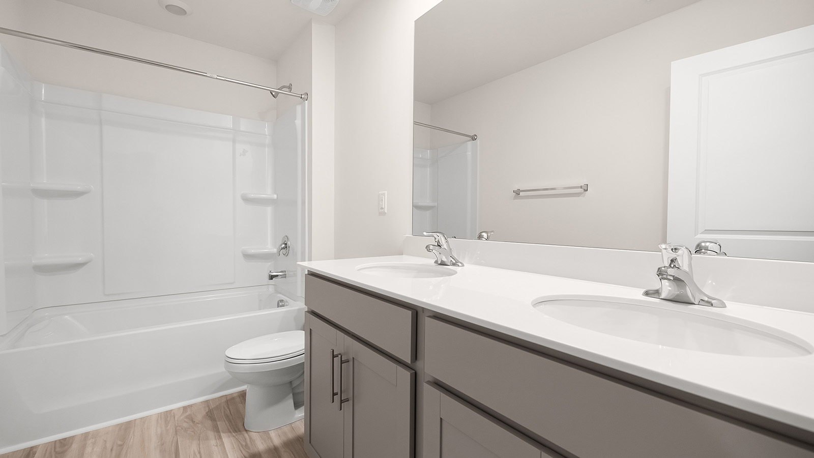 bathroom with white cabinets and counters, and bathtub