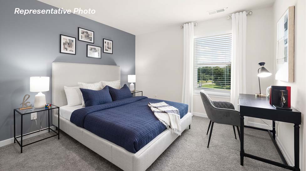 Carpeted bedroom with large windows