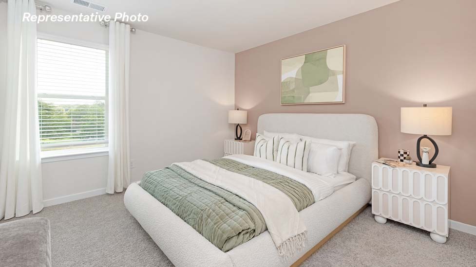 Carpeted bedroom with large windows