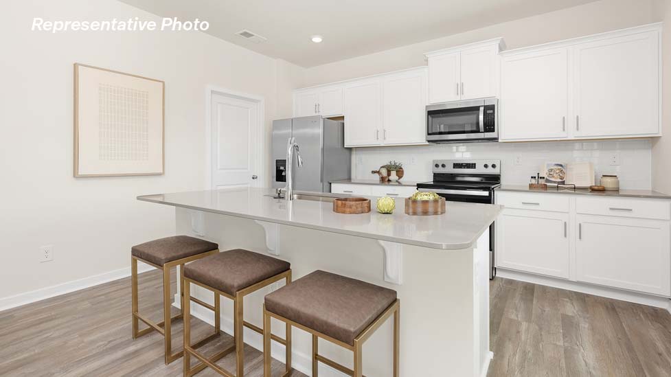 Kitchen and island with stainless steel appliances