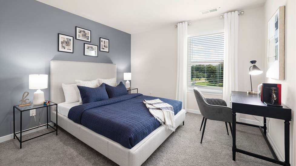 Carpeted bedroom with large windows