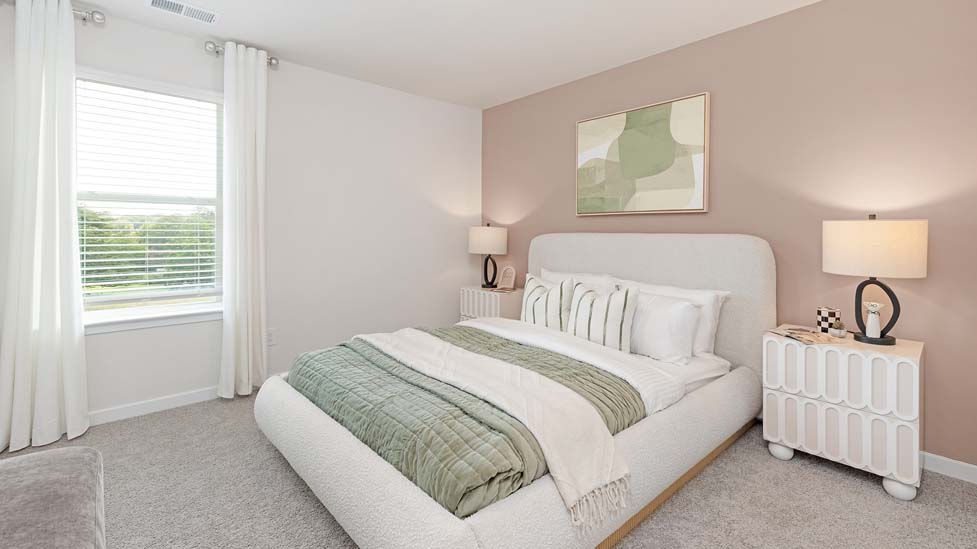 Carpeted bedroom with large windows