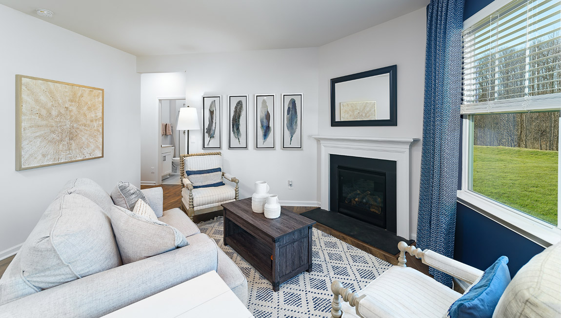 model open family room with windows and fireplace