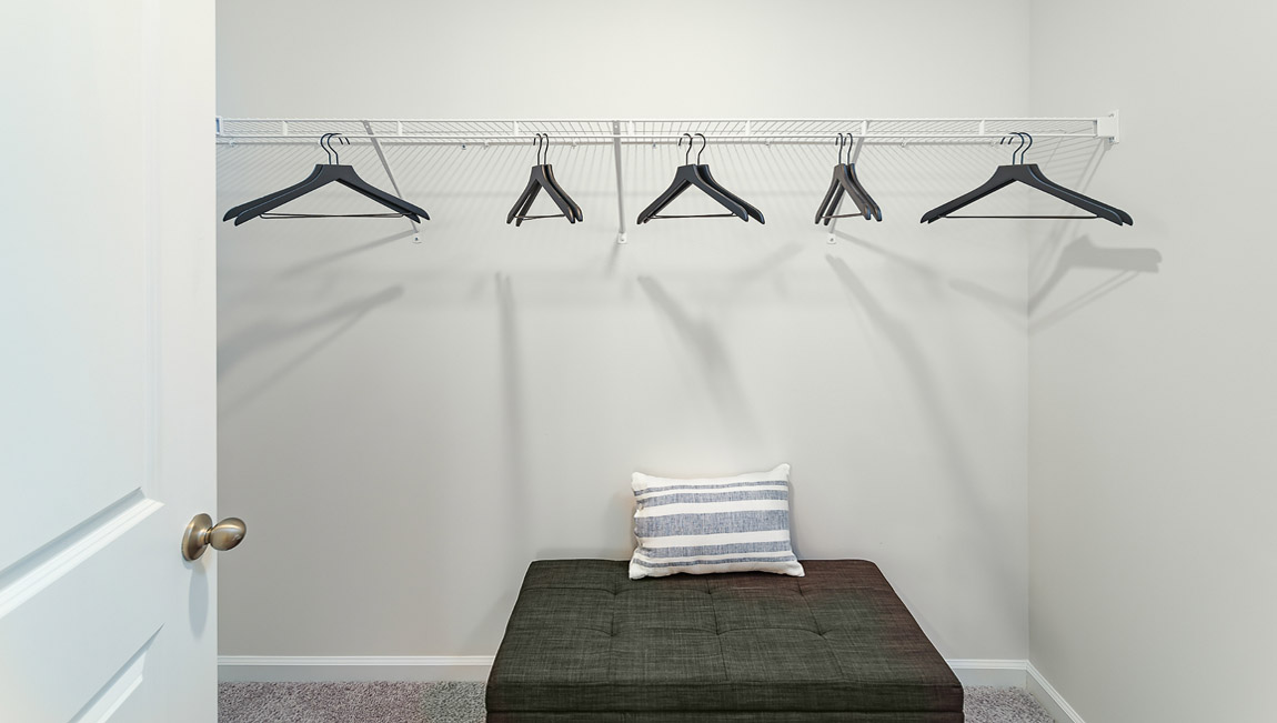 Model carpeted bedroom with small window