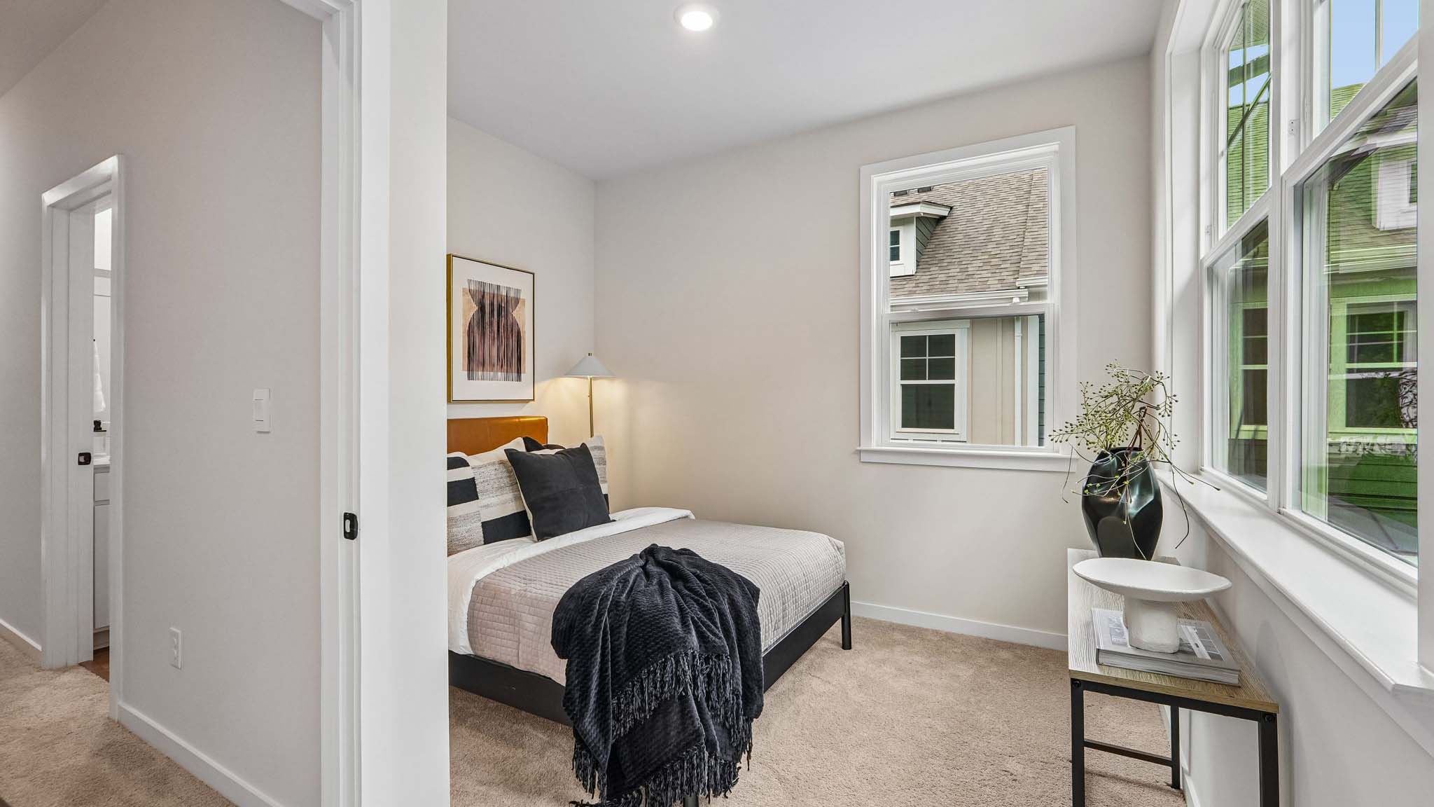 Carpeted bedroom with windows