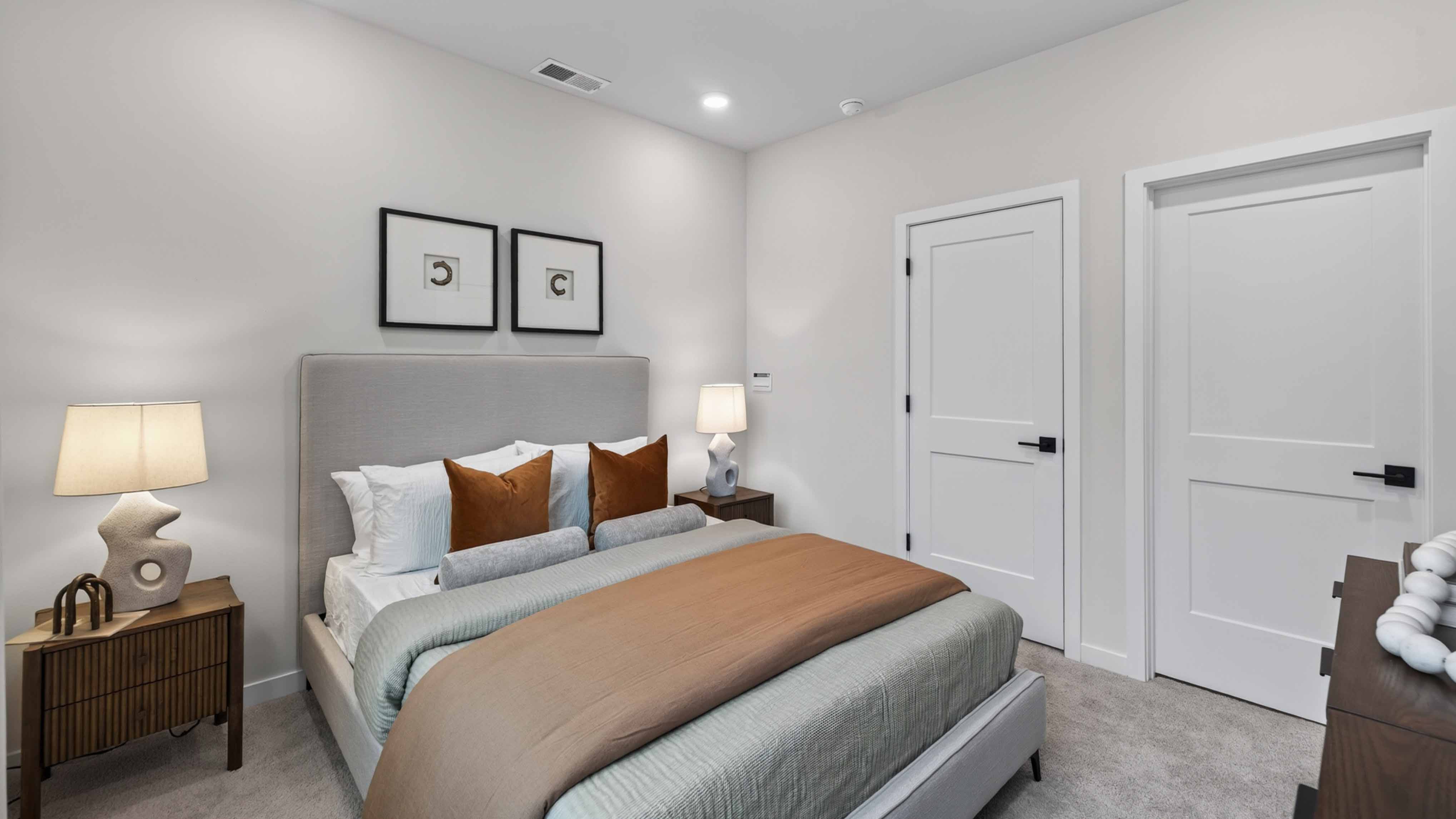 Primary carpeted bedroom with windows