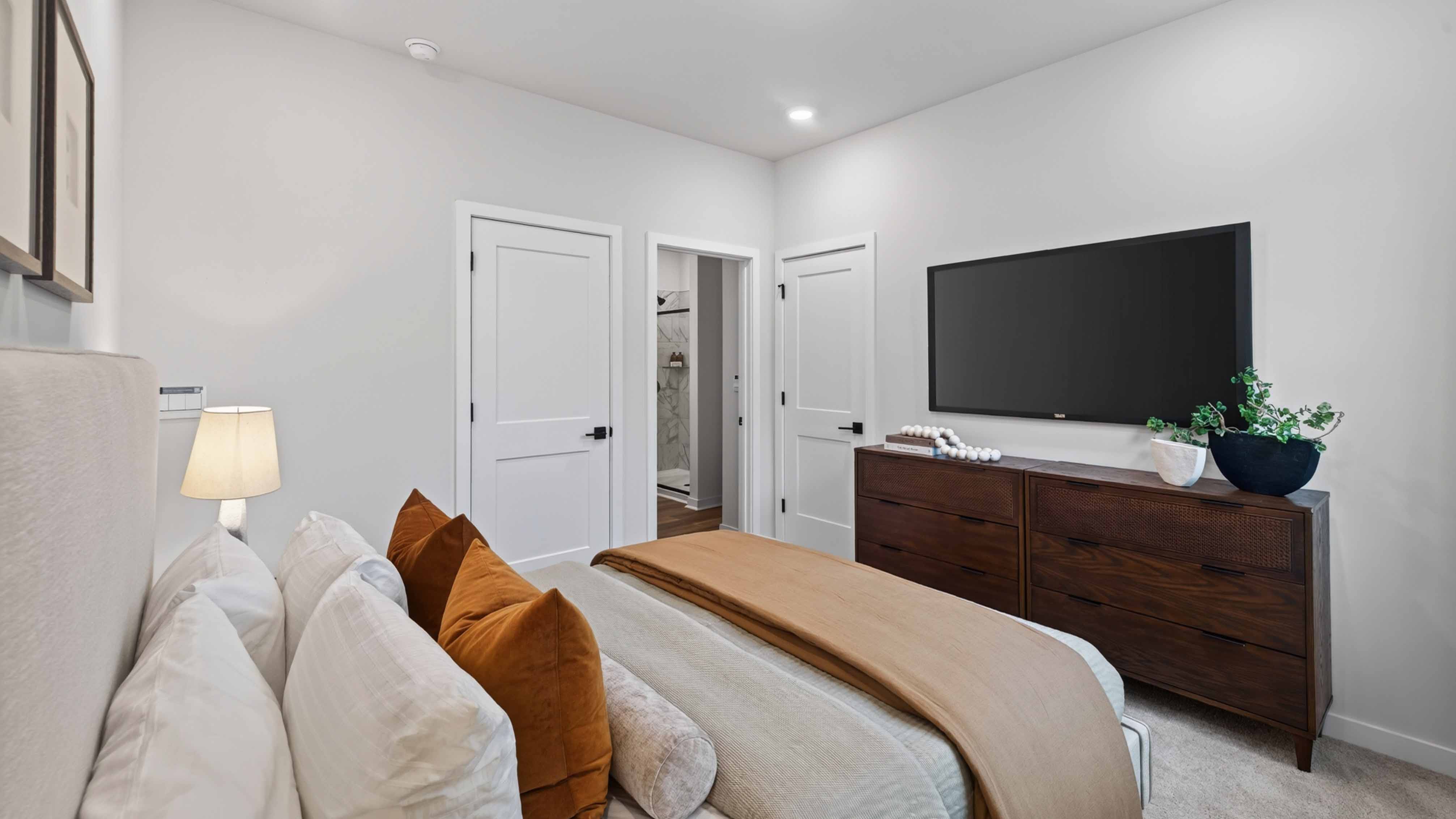 Primary carpeted bedroom with windows