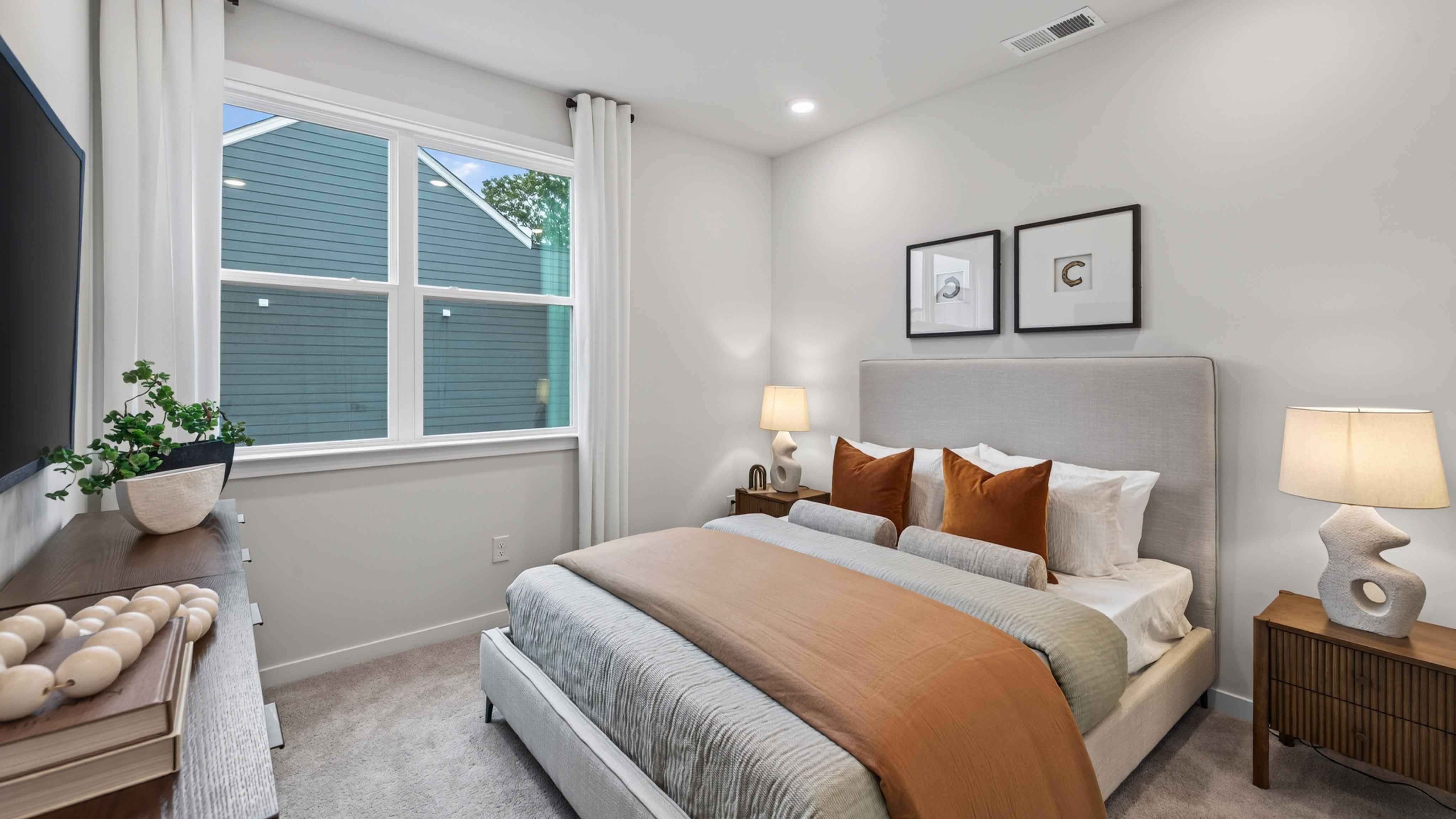 Primary carpeted bedroom with windows