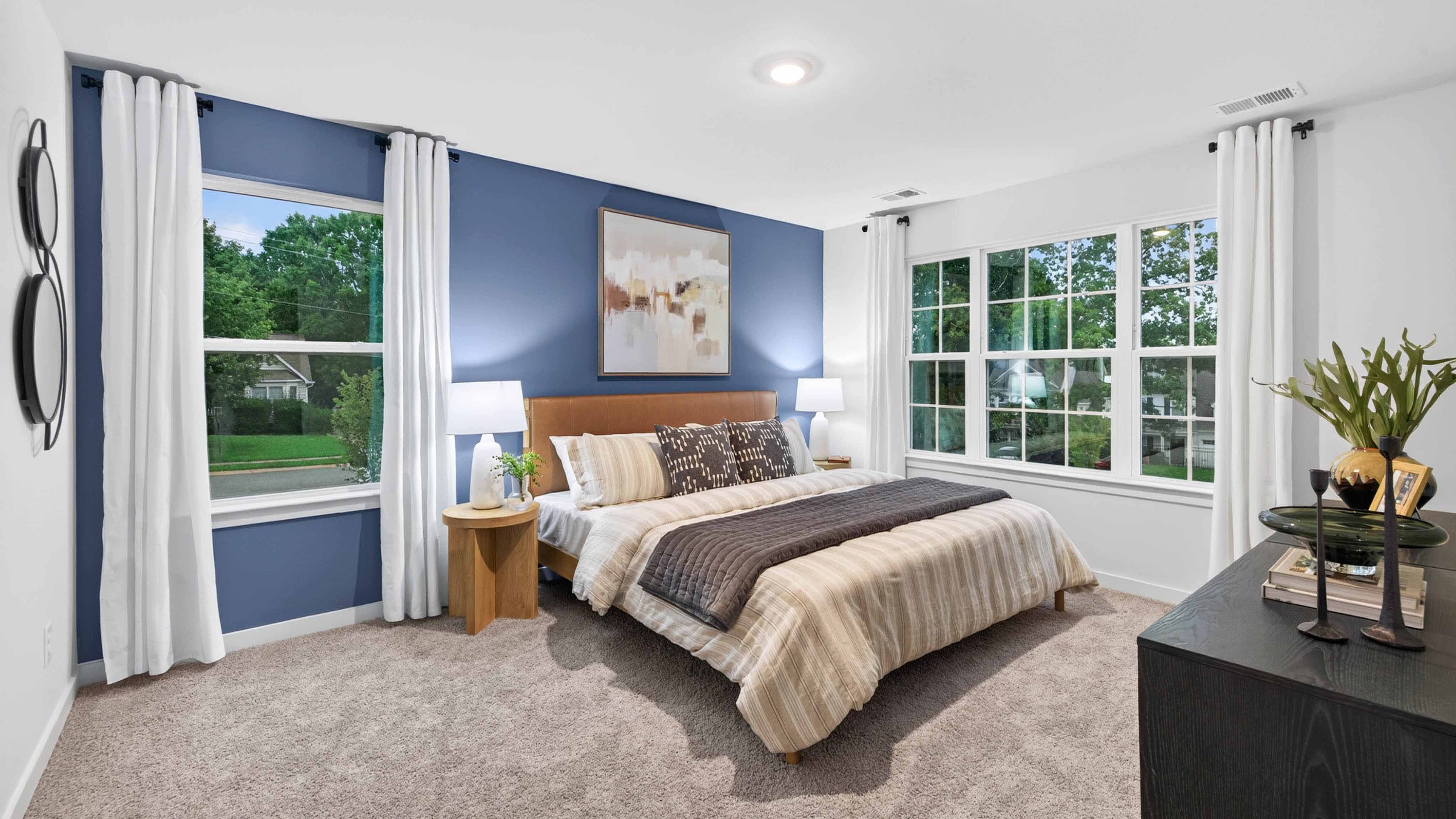 primary bedroom with carpet and large window