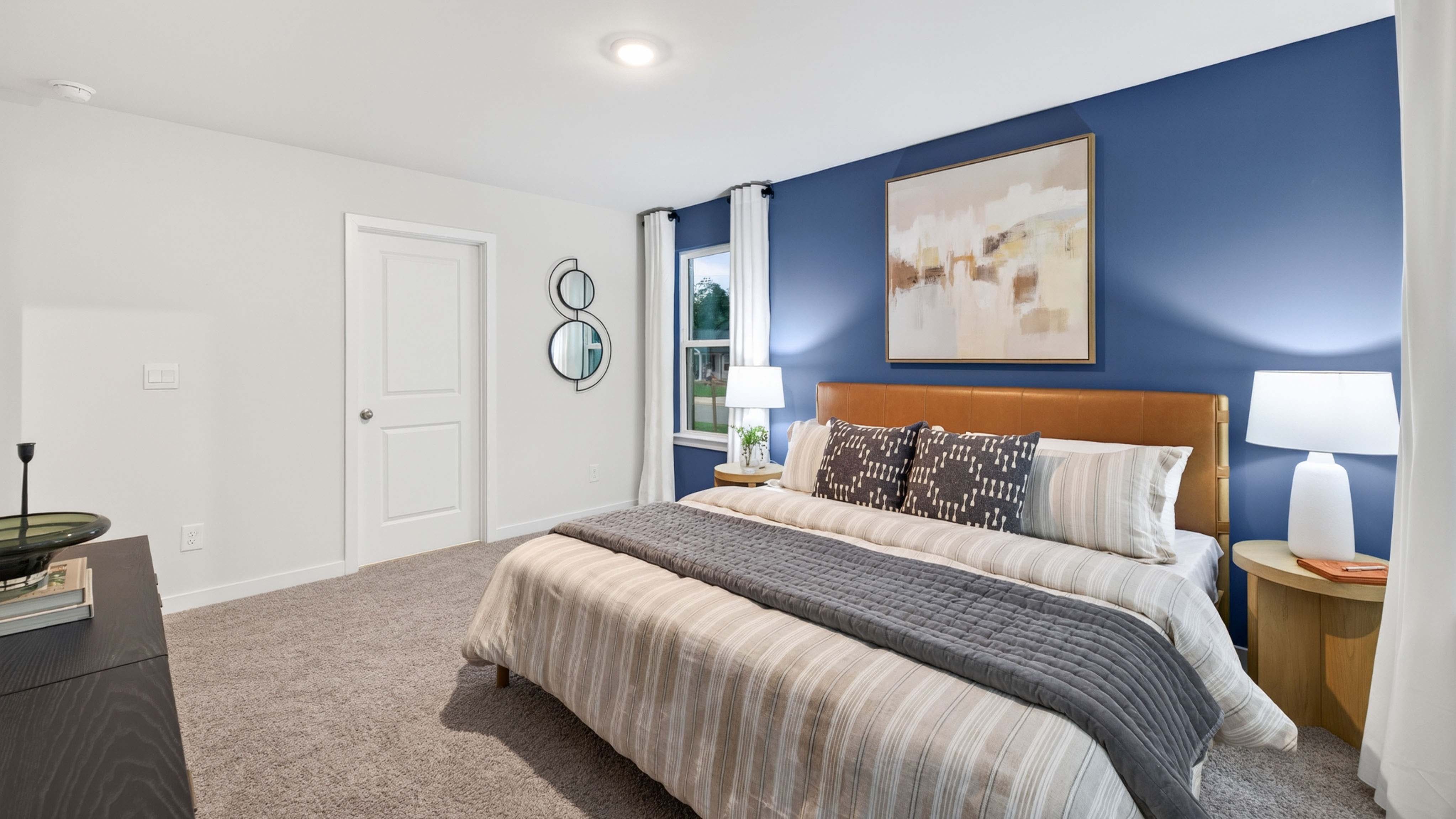 primary bedroom with carpet and large window