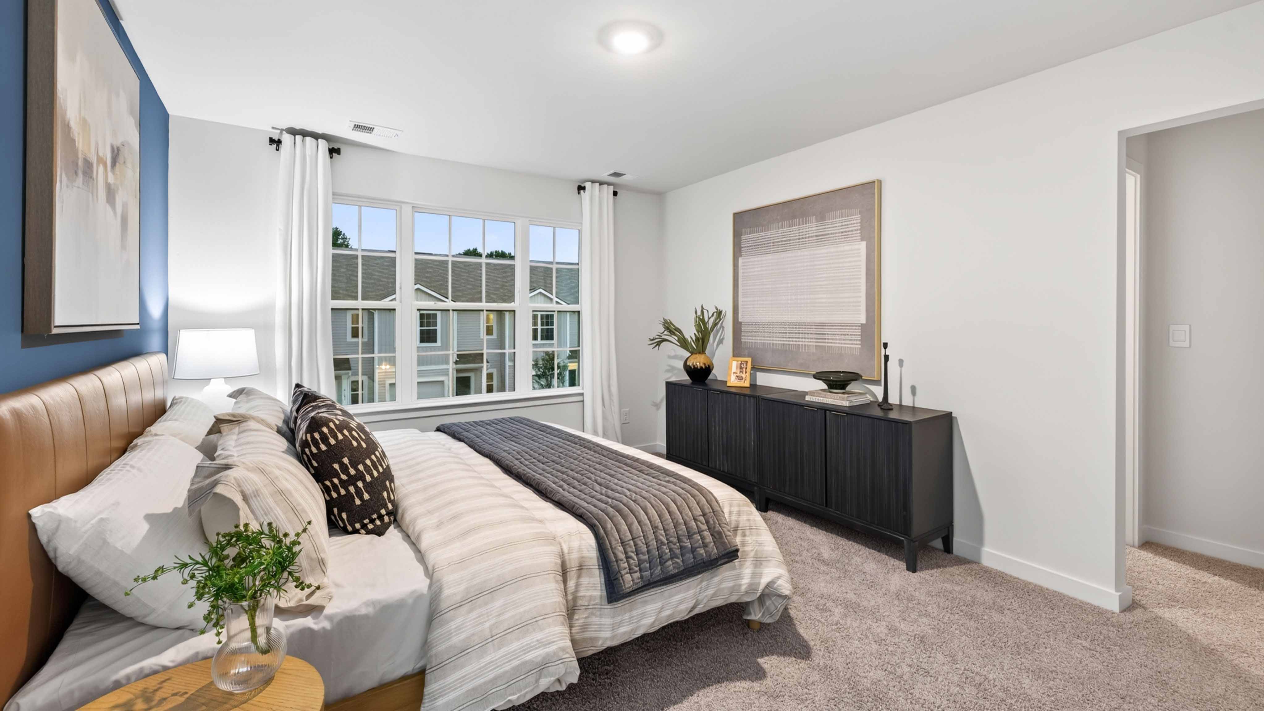 primary bedroom with carpet and large window