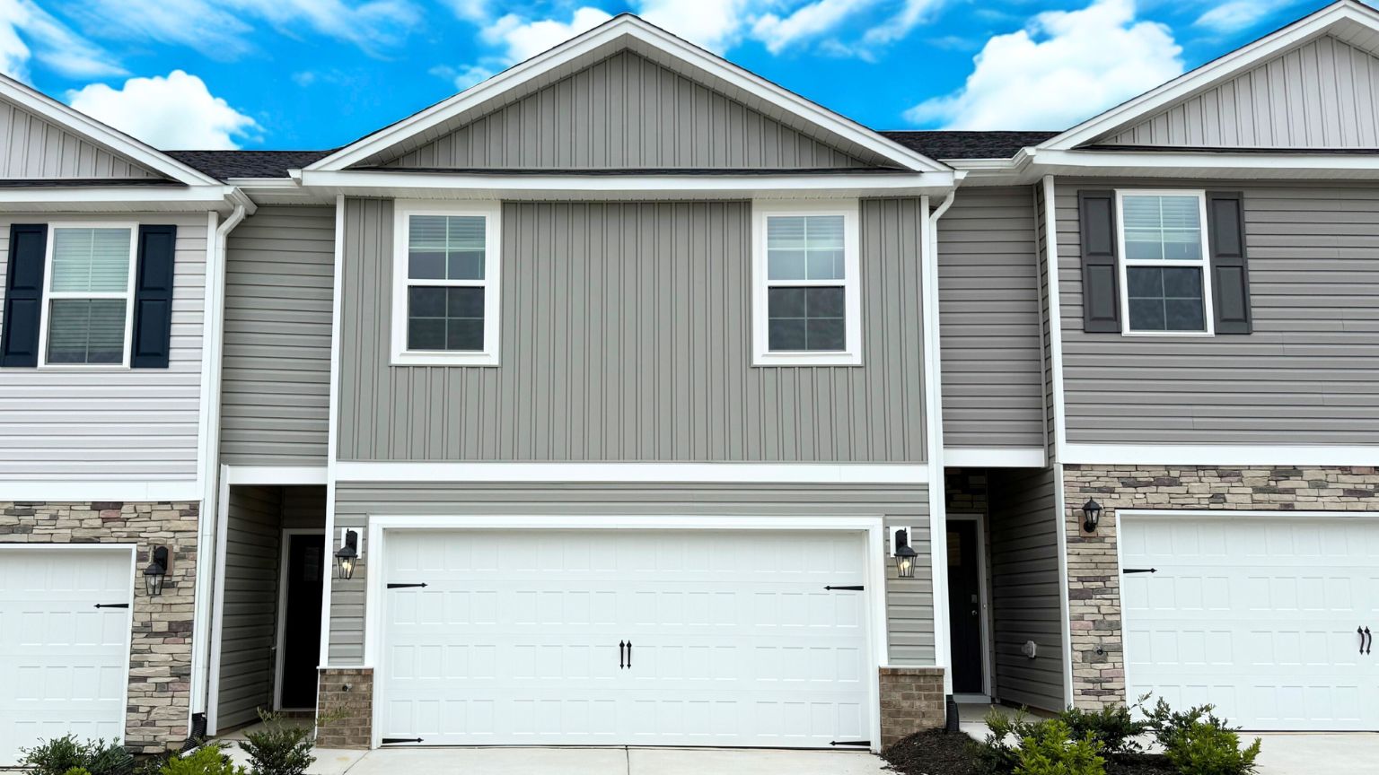 White Pattison townhome with brick and vinyl exterior