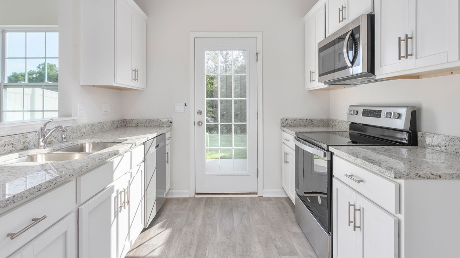 middle view of kitchen white stainless steel appliance and white cabinets