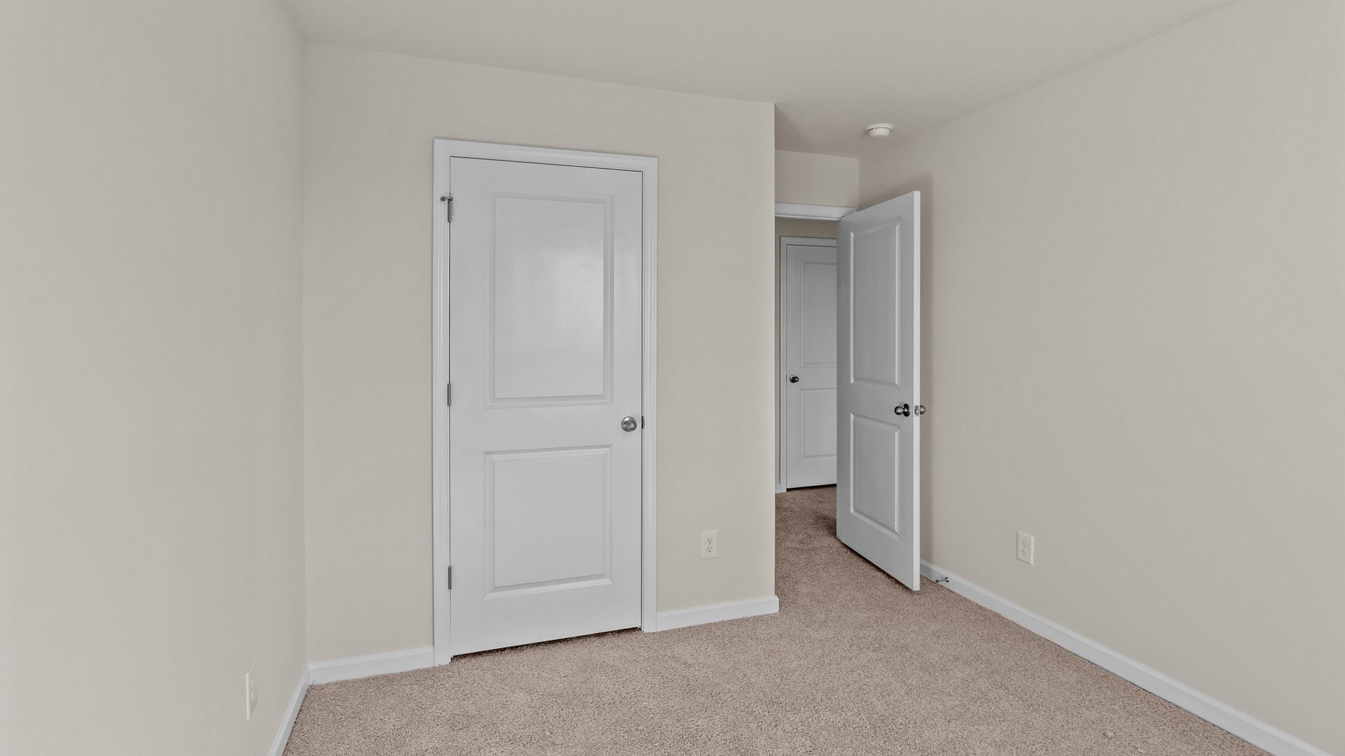 secondary bedroom with closet and carpet