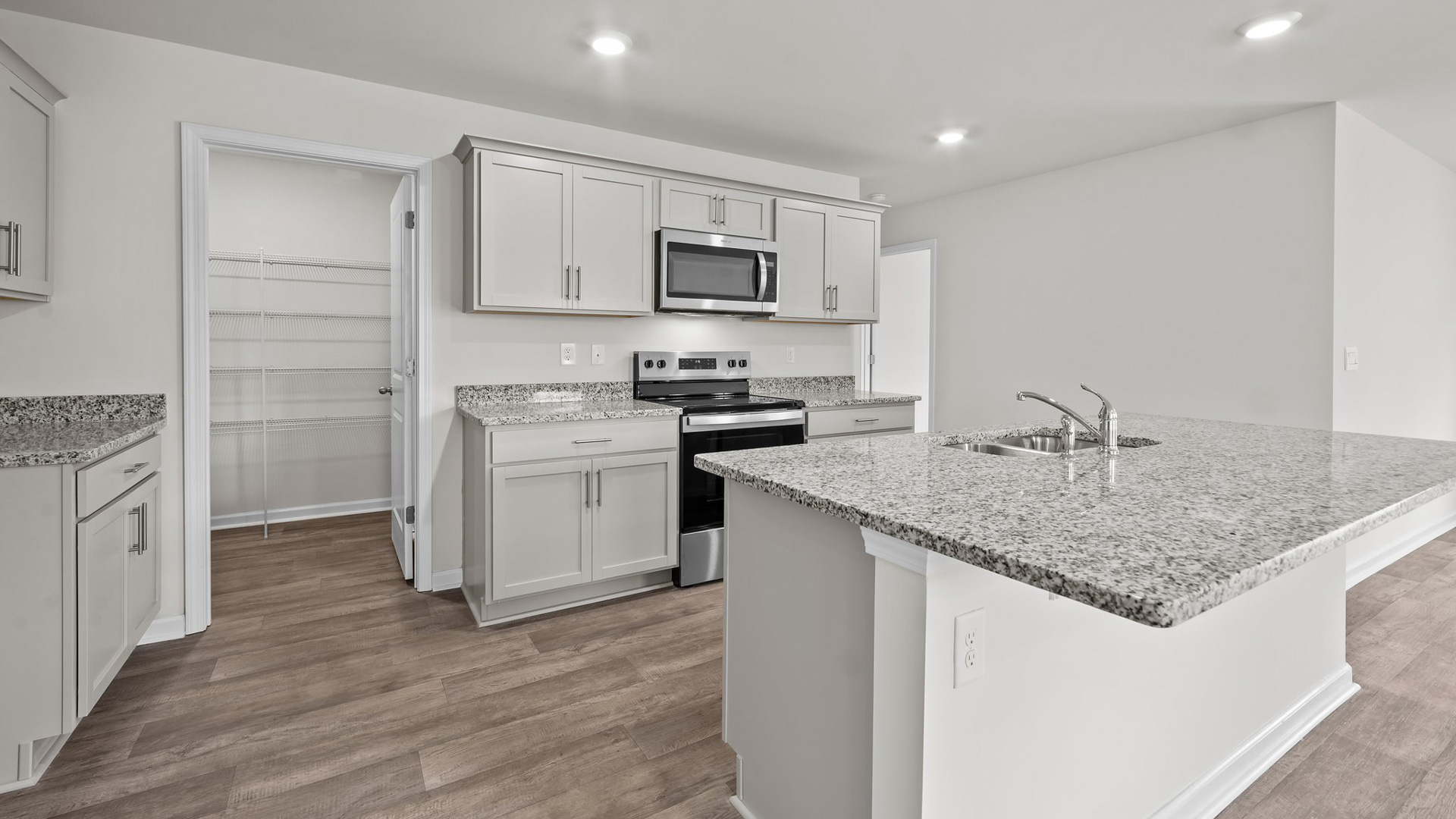 kitchen with sit in island and granite countertops