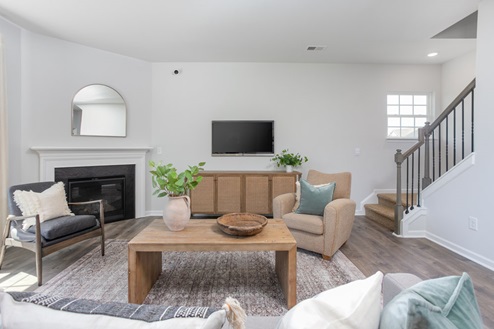living room with revwood floors and natural light