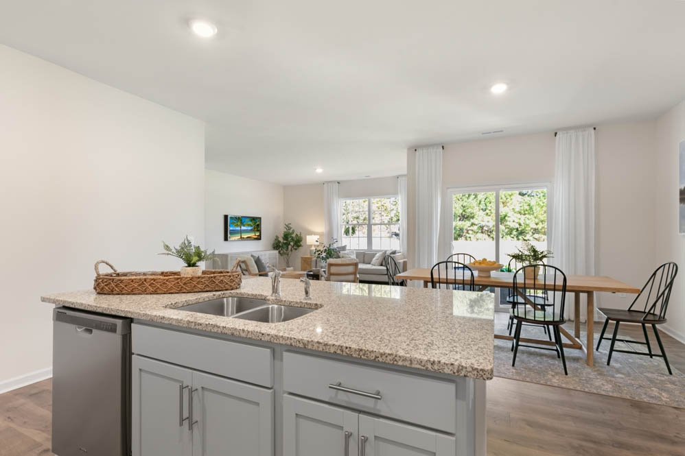 kitchen with island, revwood floors and stainless steel appliances
