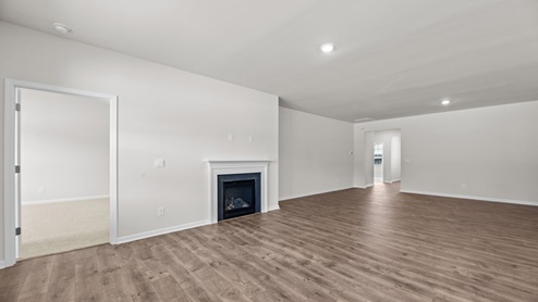 Living room with gas fireplace and revwood flooring