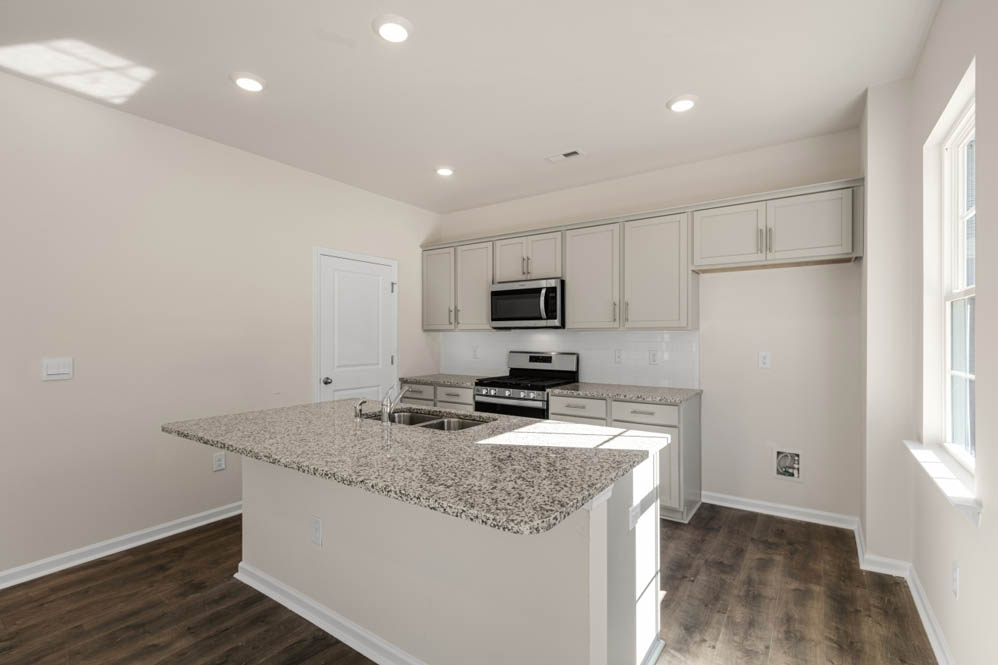 kitchen with island and revwood floors