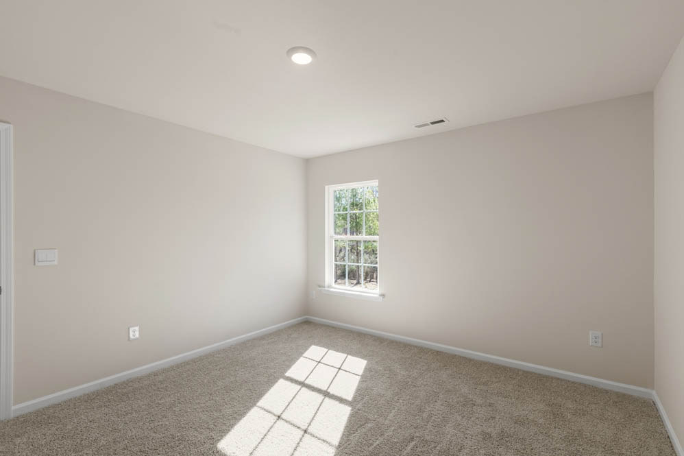 bedroom with carpet and natural light
