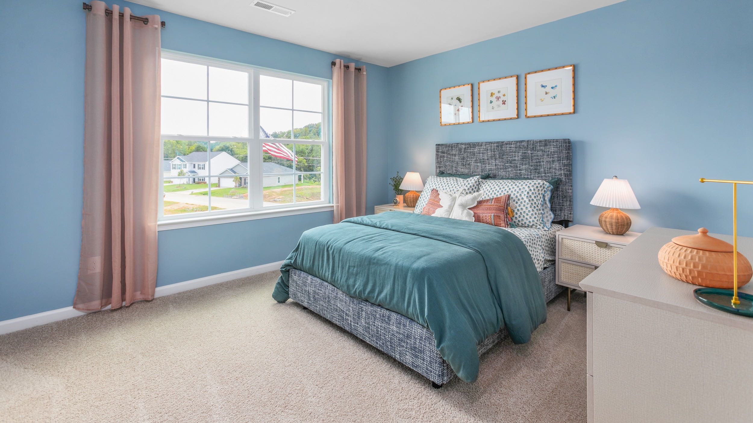 secondary bedroom with window and carpet