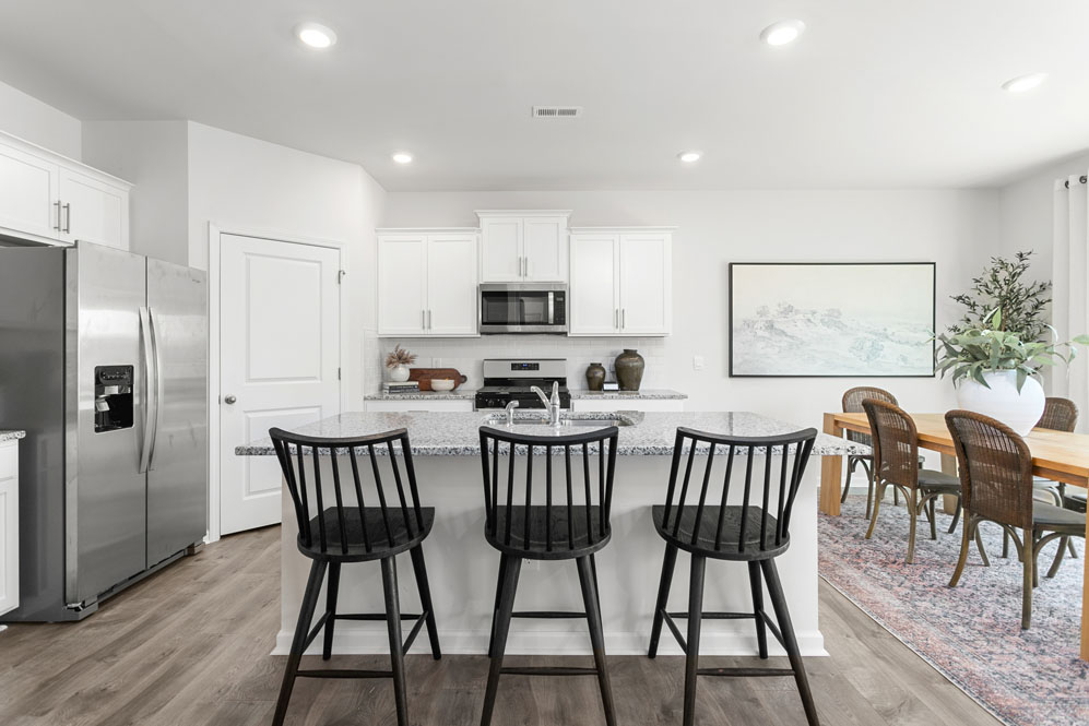 kitchen with island, revwood floor, and stainless steel appliances