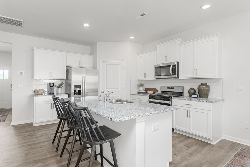 kitchen with island, revwood floor, and stainless steel appliances