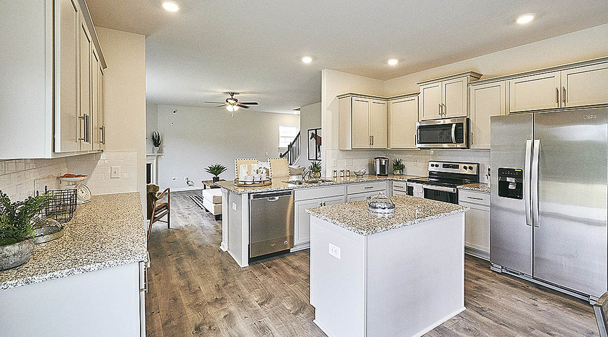 ktichen with island, revwood floors and stainless steel appliances