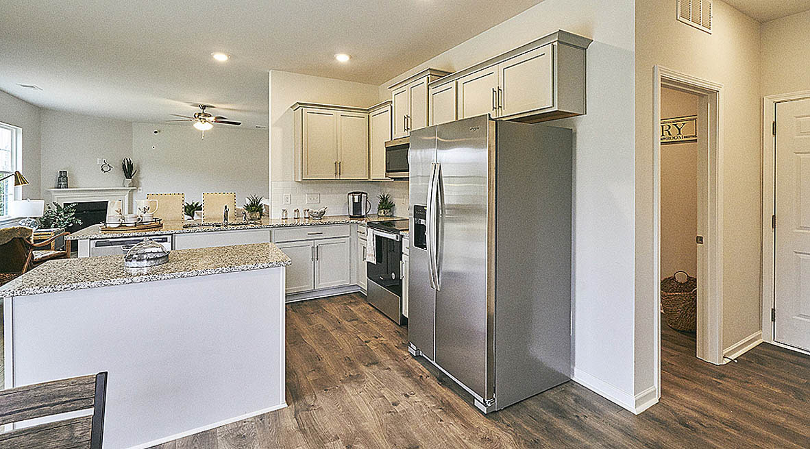 ktichen with island, revwood floors and stainless steel appliances