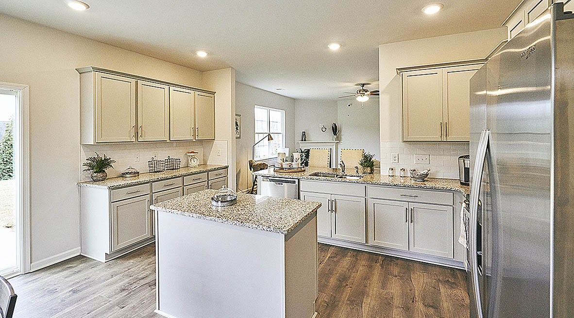 ktichen with island, revwood floors and stainless steel appliances