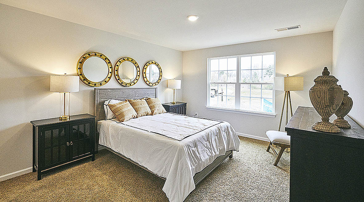 Bedroom with carpet and natural light