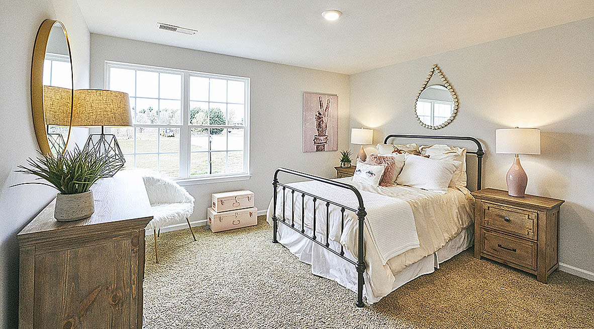 Bedroom with carpet and natural light