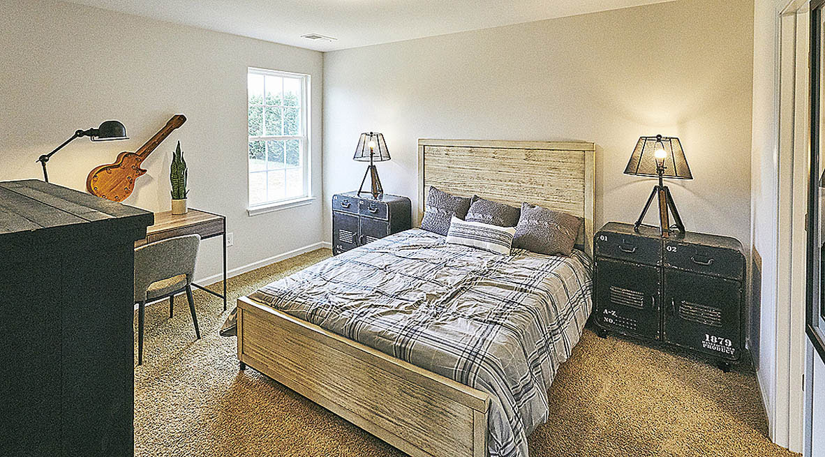 Bedroom with carpet and natural light