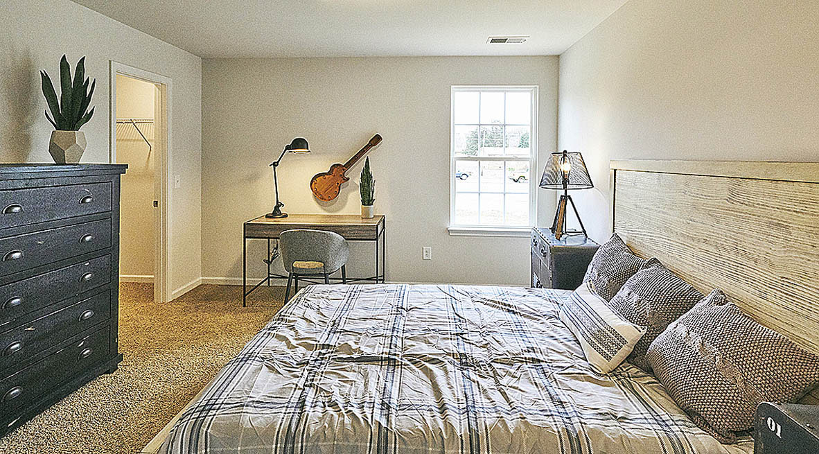 Bedroom with carpet and natural light