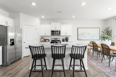 kitchen with revwood floors an island and stainless steel appliances